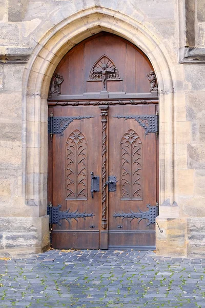 old wooden door entrance to the house, concept of the beginning of a new life, magic portal, medieval European architecture, history of cities