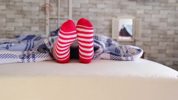 Mädchen Schläft Bett Unter Einer Karierten Decke Rot Gestreiften Socken — Stockvideo