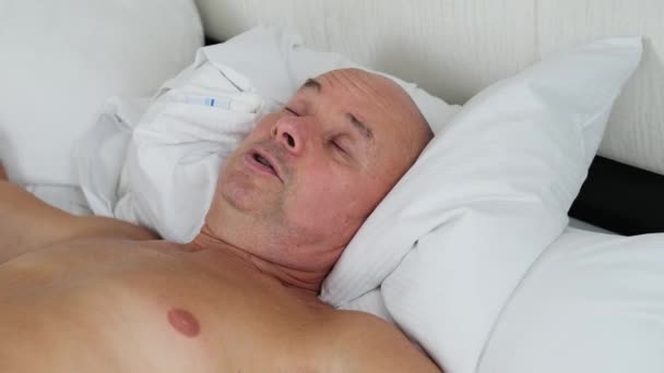 老年人睡在床上的白色被褥 公务旅行的概念 健康的睡眠 失眠问题 — 图库视频影像