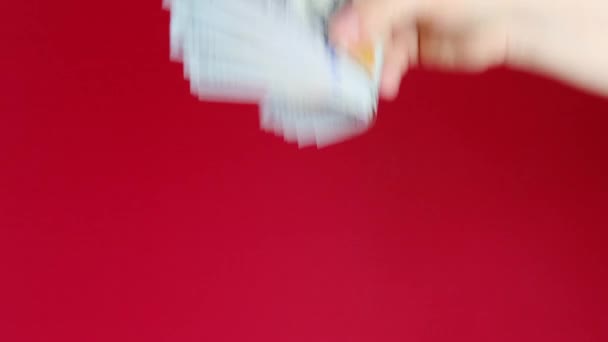 女性の手にはドル 赤の背景には米ドル紙幣 お金の束 現金の概念 支払い — ストック動画