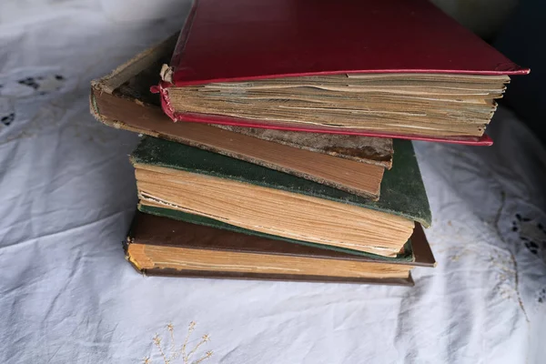 old photo albums lie on a white mint tablecloth, vintage photographs, concept of family tree, genealogy, childhood memories, connection with ancestors