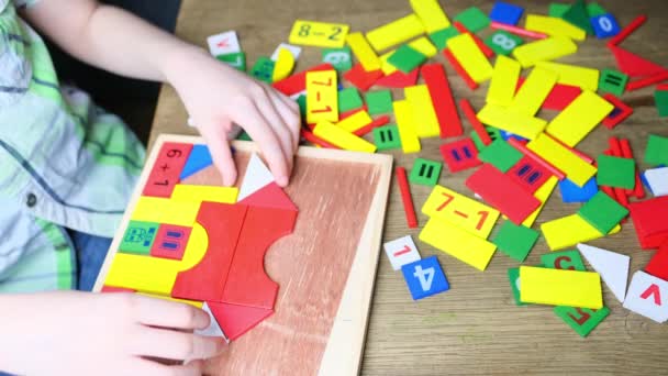 Child Kid Plays Colored Wooden Cubes Builds Houses Rockets Concept — Stock Video