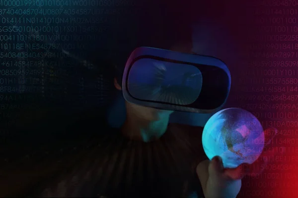 boy, child in dark room with neon lights in modern VR glasses interacting with network while having virtual reality experience, concept study of another world, modern teaching technologies