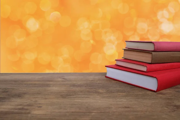 stack of paper books lie on a wooden table, concept of education, reading, traditional paper books as an alternative to electronic gadgets