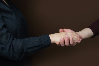 close-up of female and male hands, handshake, concept of greeting, love, relationship, trust, friendly support clipart