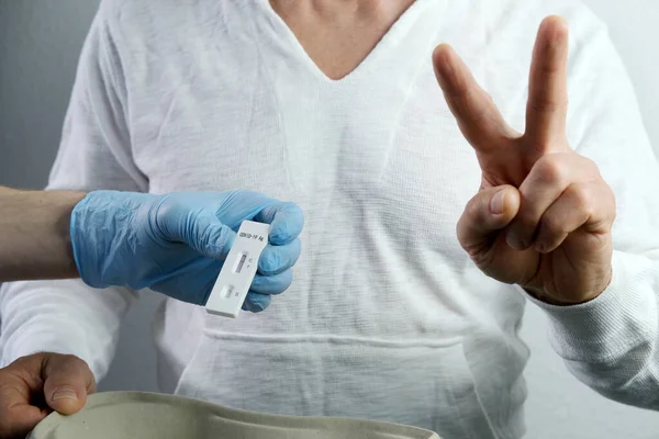 close-up of a male medic's hand holding a test cassette, medical disposable sterile test kit for rapid test covid-19, concept of early detection of viral disease, SARS-CoV-2 epidemic, coronavirus