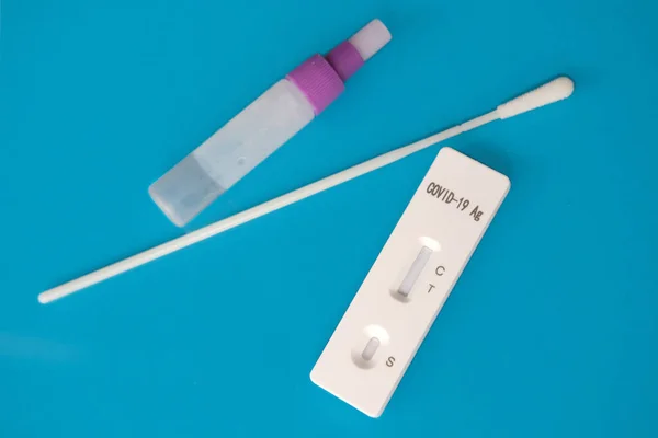 close-up of medical disposable sterile kit for rapid antigen test covid-19 on a blue background, concept for early detection of viral disease, presence of virus, SARS-CoV-2 epidemic, coronavirus