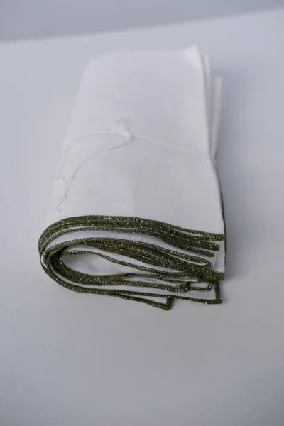 White Linen Fabric Napkin Rolled Several Layers Lies Light Background — Stock Photo, Image