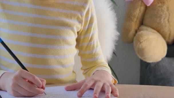 Child Schoolboy Yellow Shirt Writes Letters Notebook Pencil Bright Backlight — Stock Video