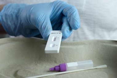 close-up of a male medic's hand holding a test cassette, medical disposable sterile test kit for rapid test covid-19, concept of early detection of viral disease, SARS-CoV-2 epidemic, coronavirus clipart