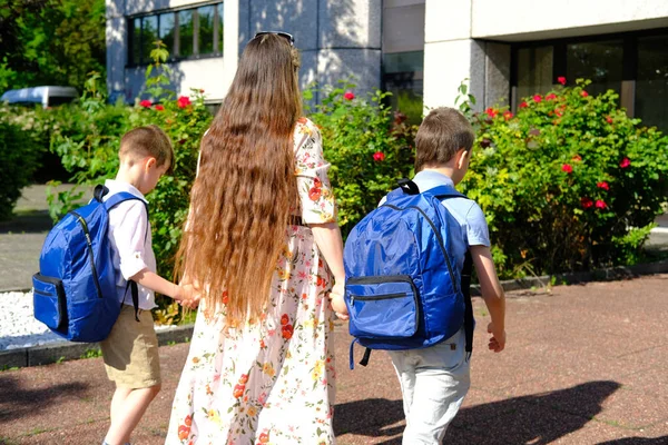 Γυναίκα Όμορφο Φόρεμα Μακριά Μαλλιά Οδηγεί Δύο Παιδιά Μπλε Σχολικές — Φωτογραφία Αρχείου