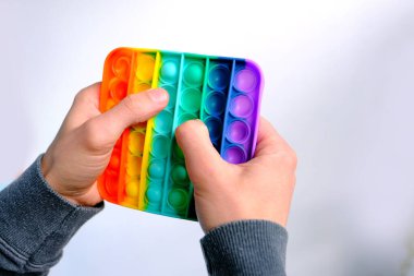 Erkek eli gökkuşağı oyuncağı antistresi Patlat, yeni oyuncak, yeni oyuncak, kauçuk baloncuklara bas, konsept eğlence, stres atma, parmak hareketlerinin gelişimi