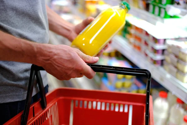 man buys food, row of shelves with groceries in a supermarket, marketing concept, prices for consumer goods, consumer basket