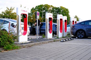 FRANKFURT, Almanya - Eylül 2021: Tesla hafif elektrikli otomobiller şarj istasyonunda pil dolduruyor, alternatif enerji geliştirme kavramı, elektrikli araç üretimi