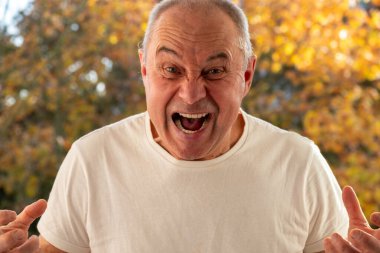 Beredeki kıdemli adam bambu bardaktan içiyor, sonbaharda açık havada sıcak içeceklerin tadını çıkarıyor, çevre dostu yaşam tarzı, doğada sıcak bir an, sürdürülebilir seçim, sonbahar ritüeli 