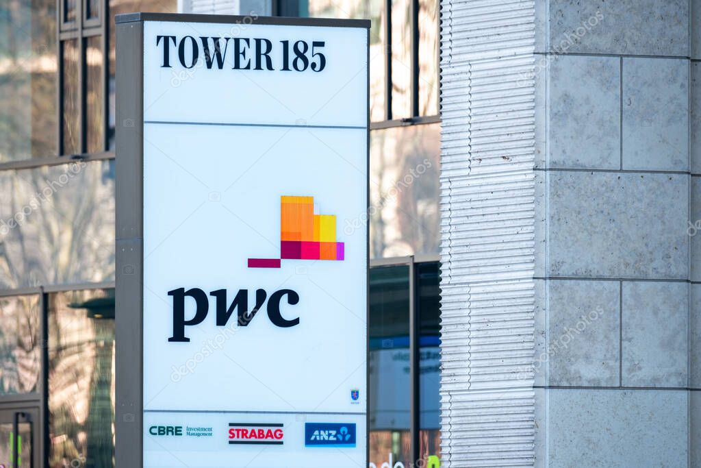 Corporate PwC logo on glass facade, high-rise glass office building against blue sky, finance and consulting, global economy, professional financial services in Germany, Frankfurt - February 9, 2025