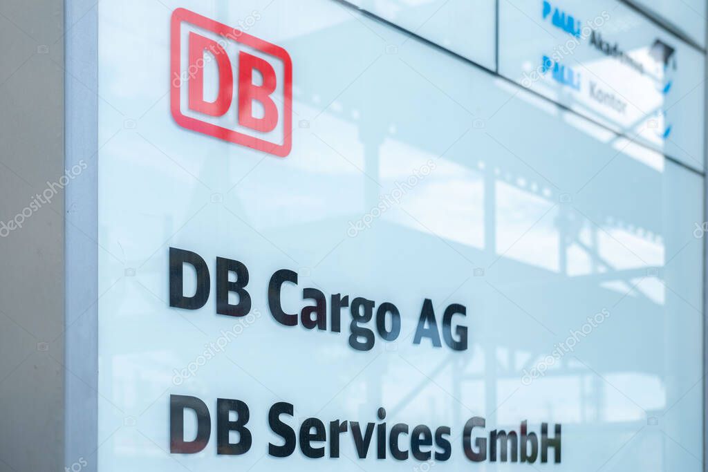 Modern sign for DB Cargo AG and DB Services GmbH with red DB logo, German conglomerate logistics, transportation, and corporate services in Frankfurt am Main, Germany - August 11, 2025