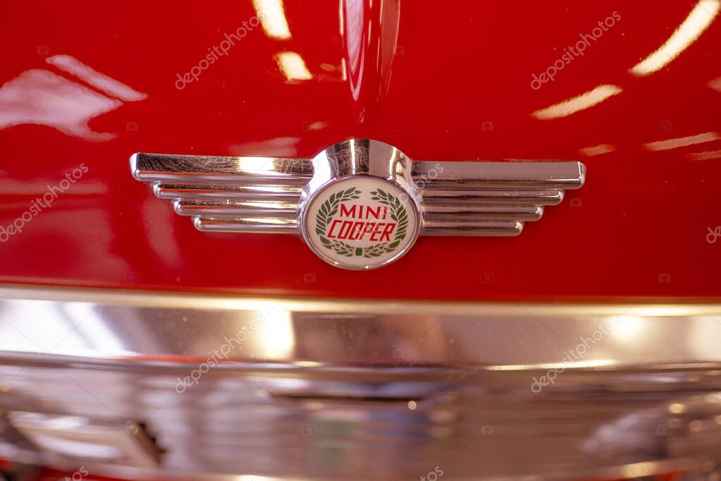Close-up logo vintage Red Classic Rover MINI Cooper 1.3 Oldtimer in showroom, iconic design technology, retro-style, Automotive Industry, Frankfurt, Germany - January 21, 2024