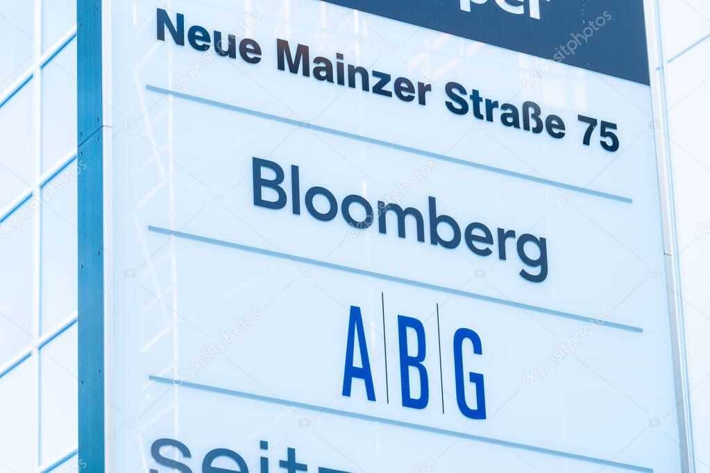Signage indicating, prominent Bloomberg logo among other companies, office complex, Modern corporate identity displayed on white panel, professional business in Frankfurt, Germany - June 30, 2025