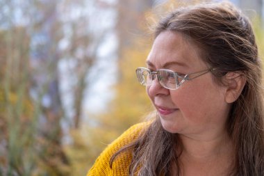 Duygusal portre mutlu olgun kadın, sonbahar parkında yürümekten zevk alan, neşeli ifadeli olgun kadın, doğal sağlıklı yaşam tarzı, sağlıklı pozitif yaşlanma portresi, kaliteli olgun yaşam