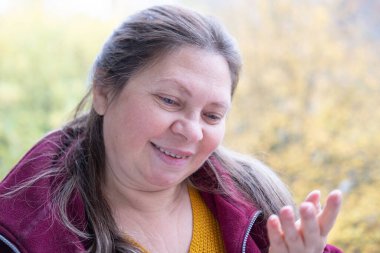 Hayal kırıklığına uğramış 50 yaşında beyaz bir kadın sunuyor, euro banknotlarını sayıyor, elinde az para, nakit ödemeler, tasarruflar, döviz kurları, finansal özgürlükler