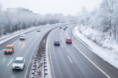 Aerial view cars driving on slippery highway autobahn near Frankfurt during heavy snowfall, winter road traffic and transportation, seasonal weather conditions in Germany, Frankfurt - February 1, 2026