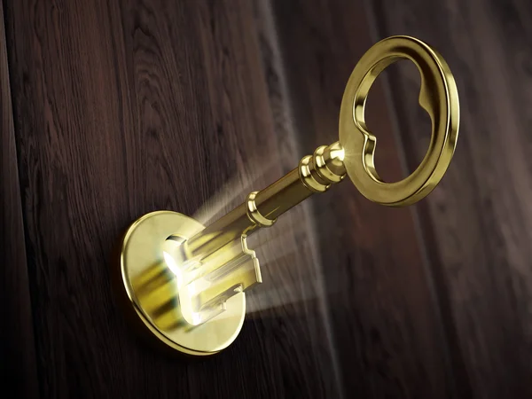 Golden key moving in keyhole — Stock Photo, Image