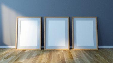 Üç boş resim çerçeveleri katta duruyor. Tasarım şablonu için Mock Up