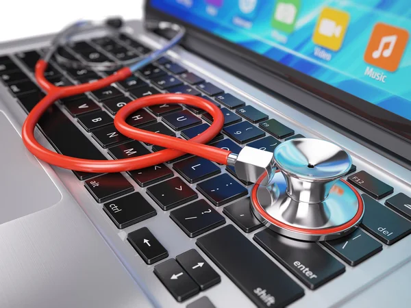 Red stethoscope on laptop keyboard — Stock Photo, Image