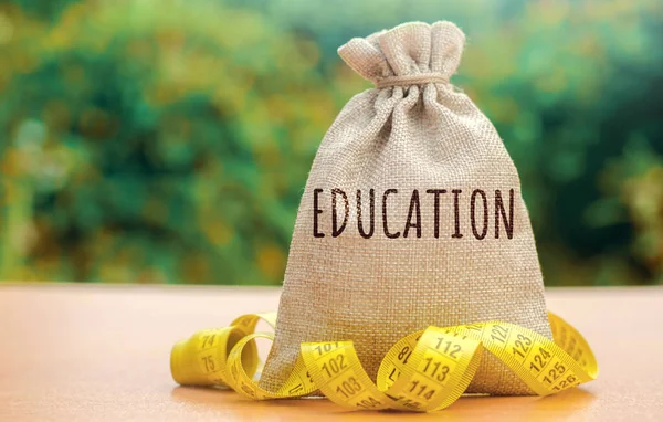 Money bag with the word Education. The concept of saving money for studies. Investments of budgetary funds in the educational system, a policy of improving quality of education