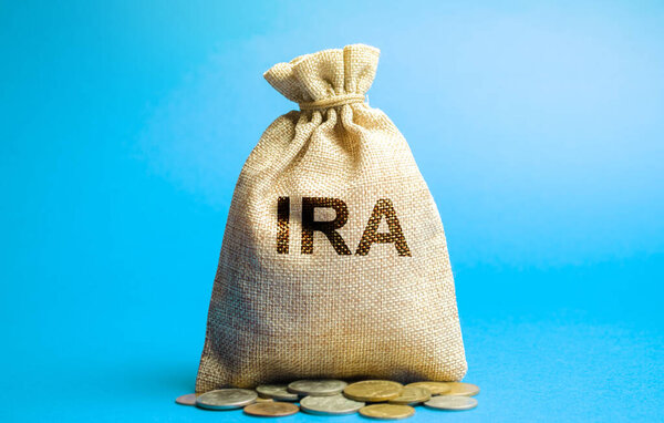 Money bag with the word IRA - individual retirement account. Tax-advantaged account that individuals use to save and invest for retirement. Business and finance concept