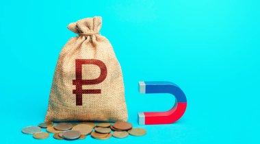 russian ruble money bag and red blue magnet. Tax collection. Raising funds and investments in business projects and startups. Accumulation and attraction of capital. Money laundering.