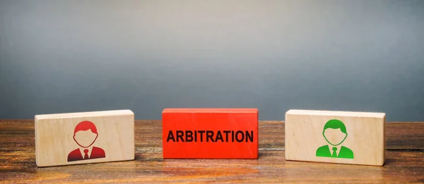 Wooden blocks with the image of two people and the word Arbitration between them. Alternative dispute resolution. Resolve disputes outside the judiciary courts. Conciliation, mediation, negotiation