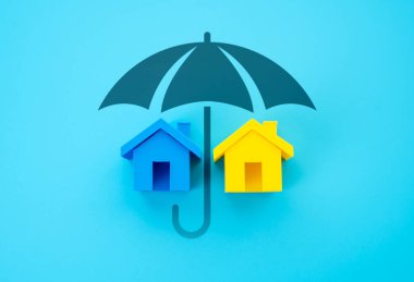 Bir şemsiye altında Ukrayna bayrağı renginde evler. Ukraynalı mültecilere ve yerlerinden edilen kişilere destek. İnsani yardım, konut güvenliği ve sosyal dayanışma