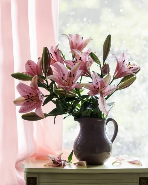Still life with bouquet of lily on the windowsill