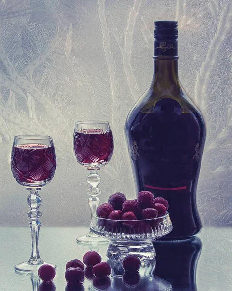 Still life with glass of cherry brandy on frost background