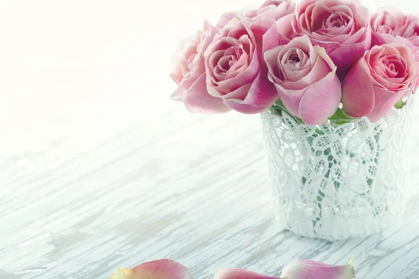 Pink roses in a white lace vase — Stock Photo, Image