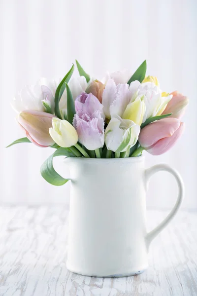 Vaso branco com tulipas coloridas Fotos De Bancos De Imagens