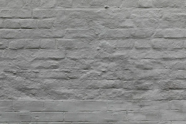 Tuğla duvarın Grunge gri arka planı. Yüzey boyanmış, beton kaplama yıpranmış. — Stok fotoğraf