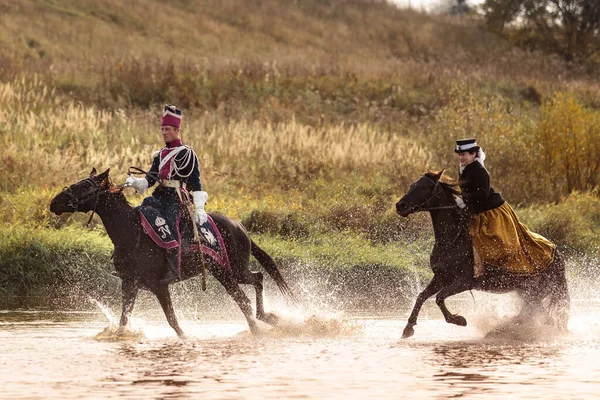 04.10.2020 Rusia, Moscú. Un grupo de jinetes de una mujer montando caballos fuerzan el río con un galope — Foto de Stock