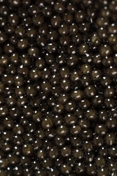The background of black caviar of premium beluga sturgeon fish. — Stock Photo, Image