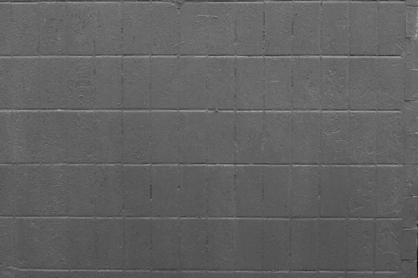 正方形のタイルの黒い背景の壁。黒塗り、荒塗りの表面 — ストック写真
