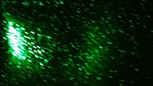 Bright green emerald background with swirling metal particles. Fire and side. The effect of movement.