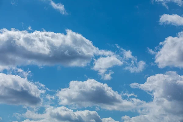 Blue skies with low clouds. Light clouds in summer weather.