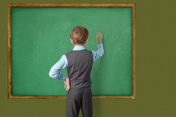 Caucasian Schoolboy School Uniform Stands His Back Camera Writes Blackboard — Stock Photo, Image