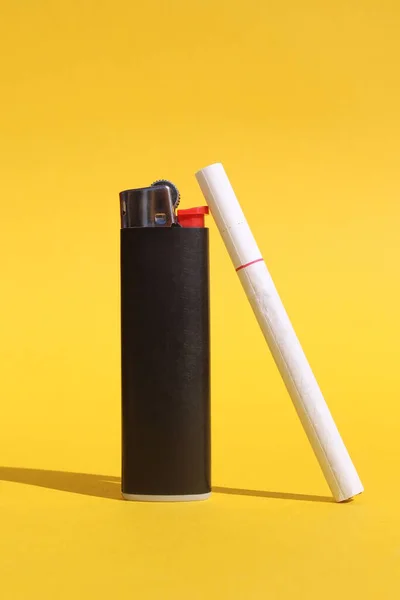 Black Lighter Cigarette Stands Yellow Background — Stock Photo, Image