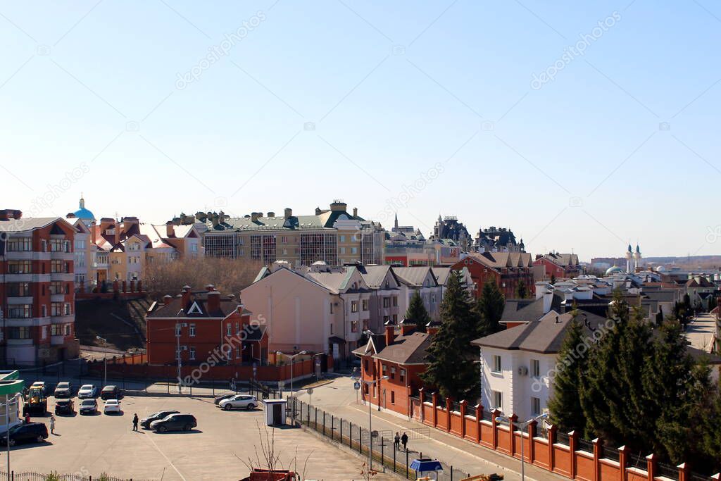 City landscape. The roofs of the houses are visible against the blue clear sky