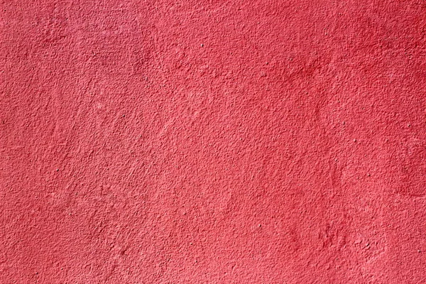 Texture bright pink smooth plastered and painted concrete wall