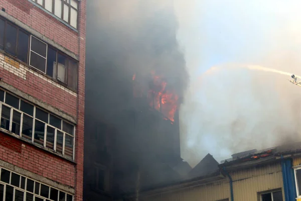 Blurred photo of a high-rise building on fire in summer on a hot sunny day