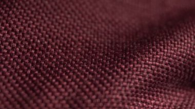 Tekstil arka planı, bordo polyester kumaş. Kaydırma makrosu